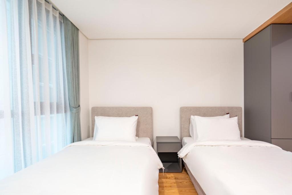 Postel nebo postele na pokoji v ubytování Centum Convention Hotel In Centum