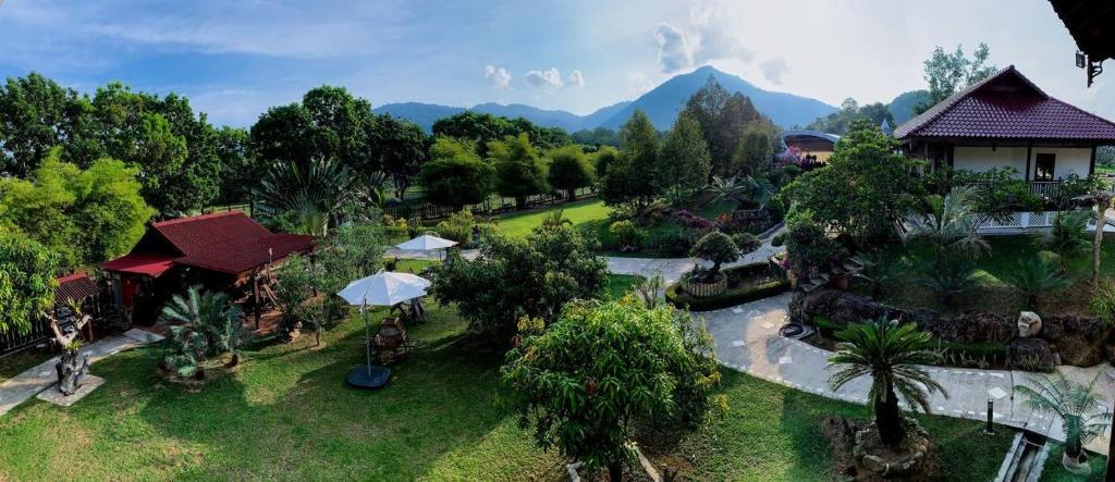 an aerial view of a resort with mountains in the background at Singgahsana Villa in Kuah