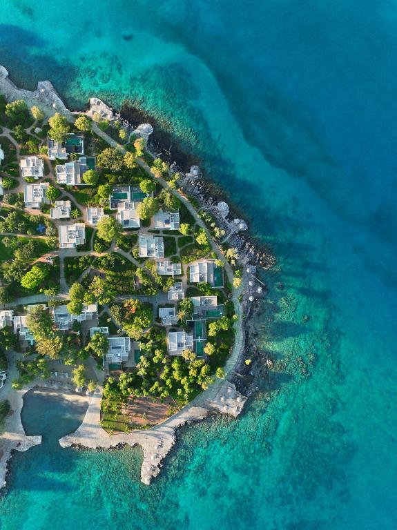 an aerial view of an island in the ocean at Minos Beach Art Hotel, a Member of Design Hotels in Agios Nikolaos