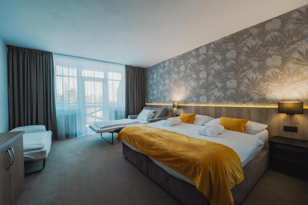 Voodi või voodid majutusasutuse Rodinný Hotel Hubert High Tatras toas