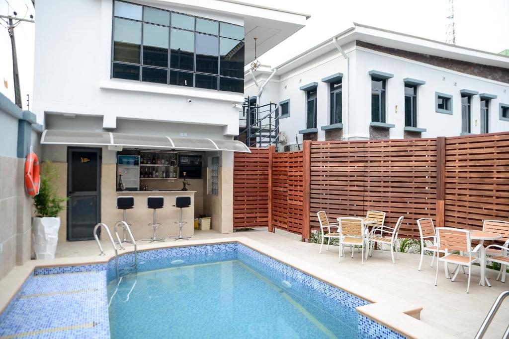 a swimming pool in front of a house at The Kingsley - La Prima Casa in Lagos