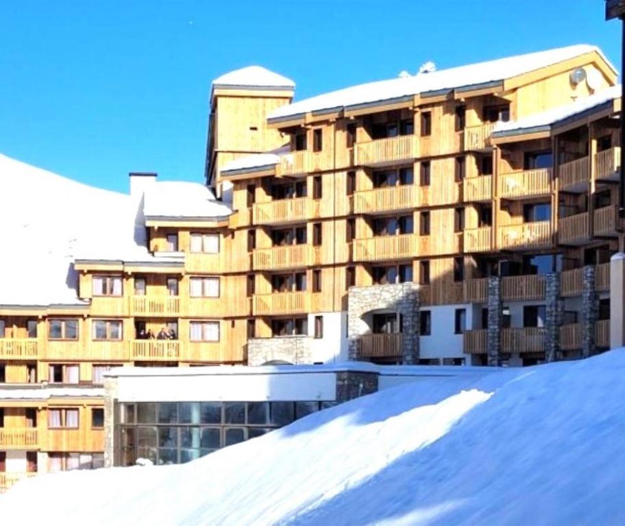 ein großes Gebäude mit Schnee davor in der Unterkunft Duplex skis aux pieds Belle Plagne in Belle Plagne