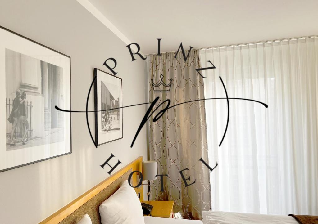 a bedroom with a sign on the wall at Hotel Prinz in Munich