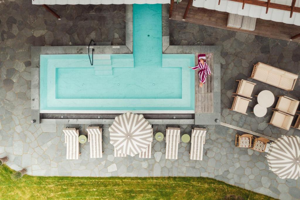 an overhead view of a swimming pool and some furniture at Ad Astra by Elite - Hotel, Spa & Resort in Södertälje