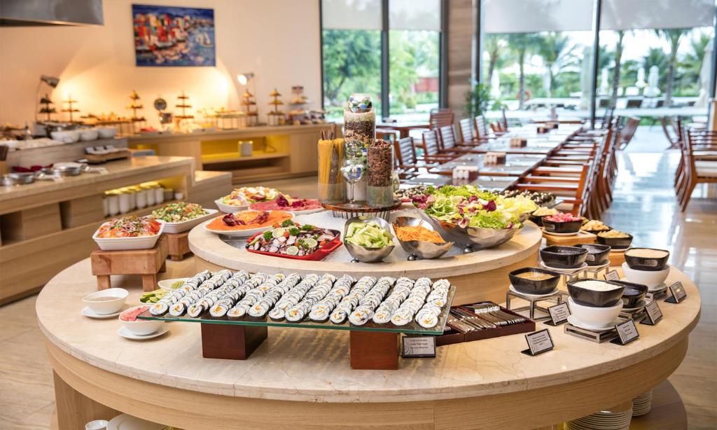 a buffet of food on a table in a restaurant at Cam Ranh Riviera Beach Resort & Spa in Cam Ranh