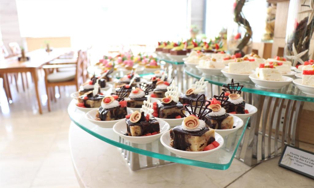 a bunch of desserts on display in a buffet at Cam Ranh Riviera Beach Resort & Spa in Cam Ranh