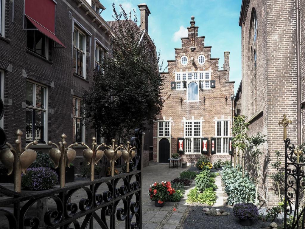 a gate in front of a building with a clock tower at Spacious holiday home in Enkhuizen with terrace in Enkhuizen