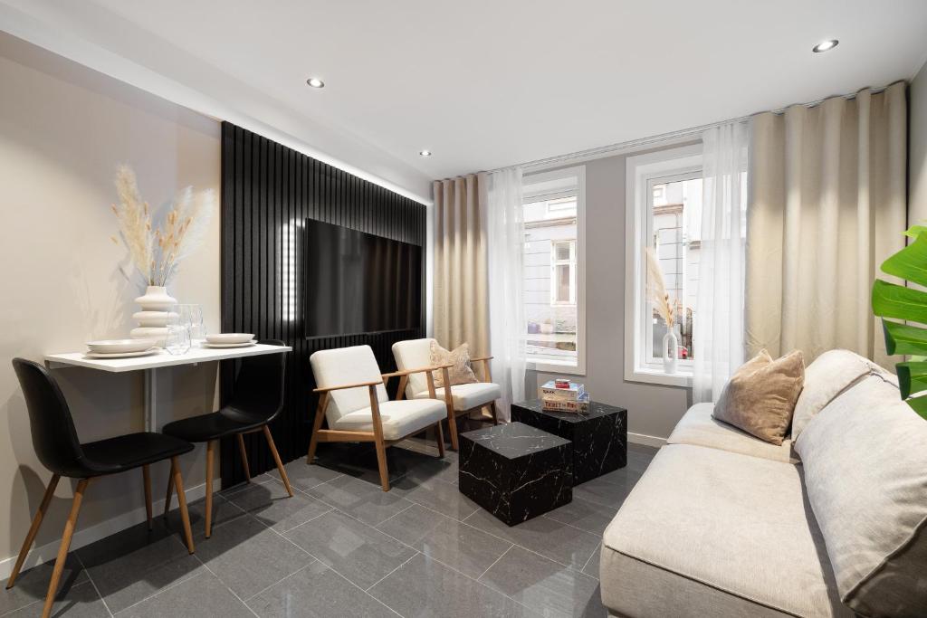 a living room with a couch and a table at Renovated jan 24 - Queen beds - Behind Bryggen in Bergen