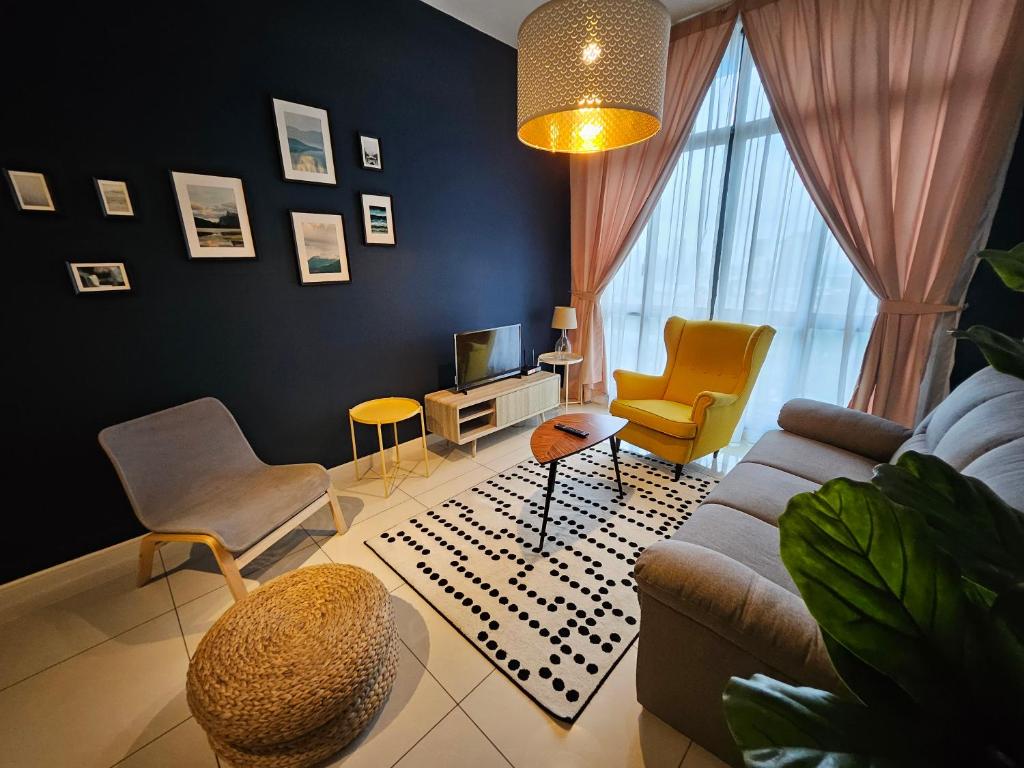 a living room with a couch and chairs and a tv at Setia Sky88 Johor Bahru in Johor Bahru