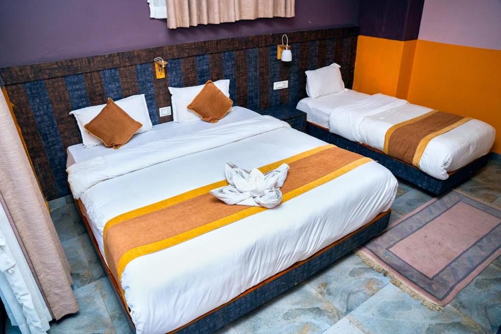 Postel nebo postele na pokoji v ubytování Hotel Kamana