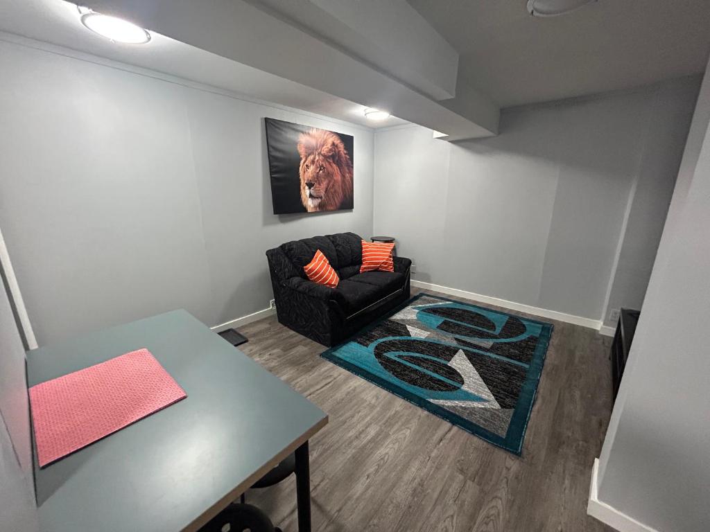 a living room with a couch and a table at Cute Highlandpark (Lower A Unit) in Calgary