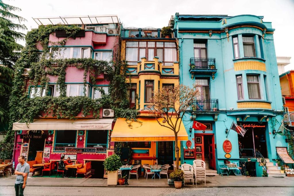 a colorful building with tables and chairs in front of it at Hotel Han in Istanbul