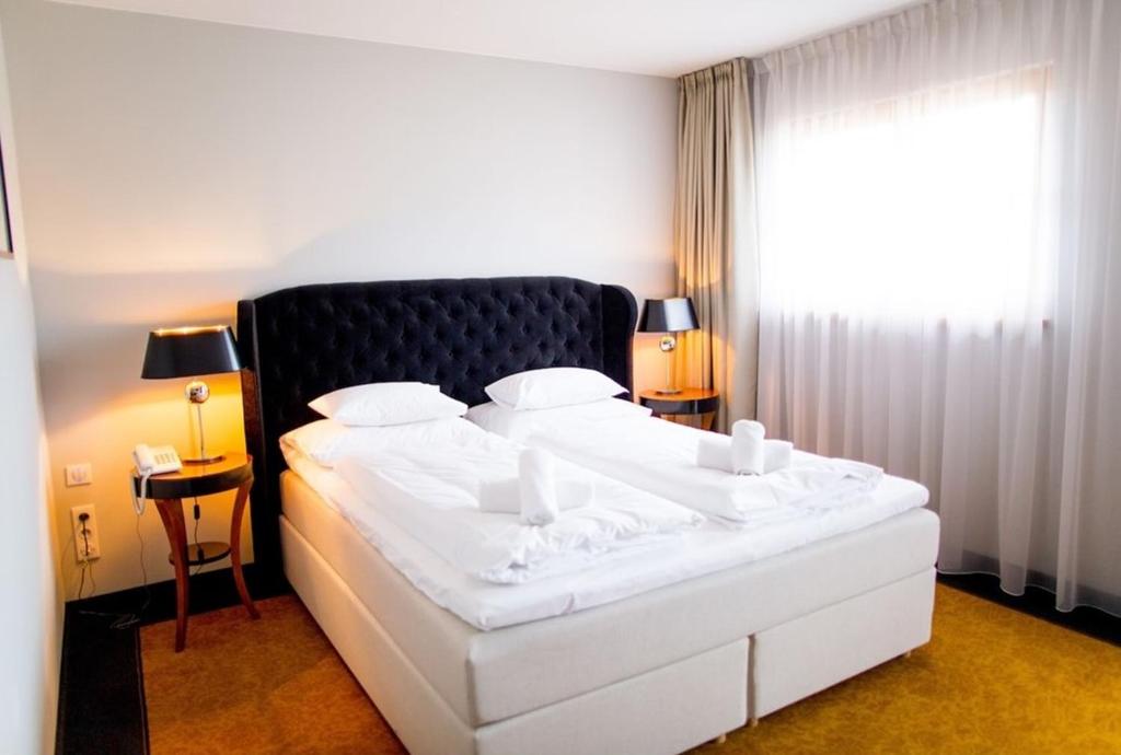 Postel nebo postele na pokoji v ubytování Pałac na Wodzie Hotel & SPA