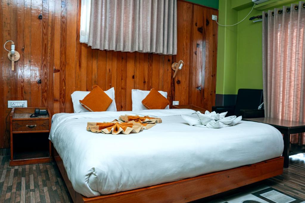 Postel nebo postele na pokoji v ubytování Hotel Kamana
