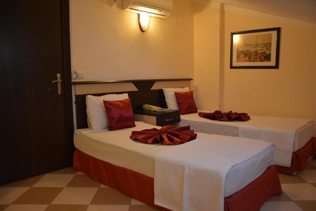 Postel nebo postele na pokoji v ubytování Yavuzhan Hotel