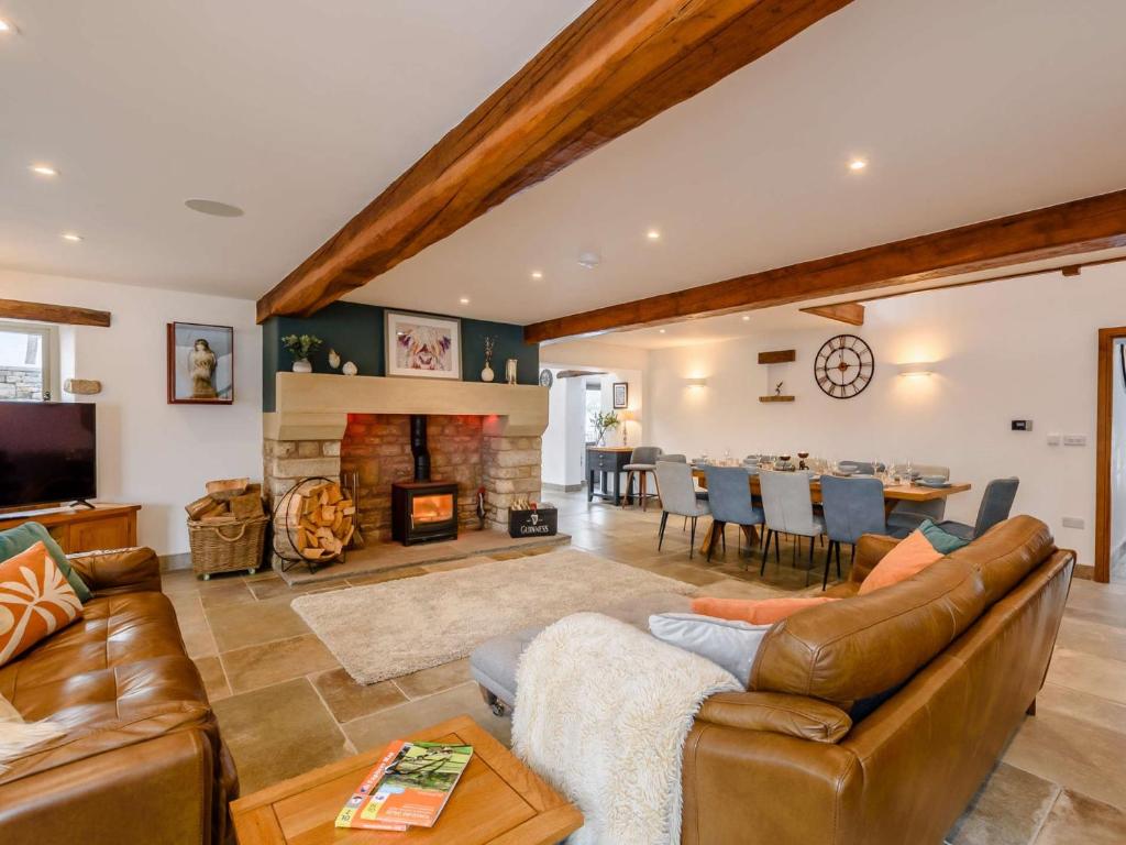 a living room with a couch and a fireplace at 5 Bed in Ingleton 90546 in Burton in Lonsdale
