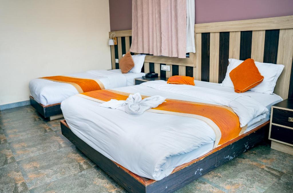 Postel nebo postele na pokoji v ubytování Hotel Kamana