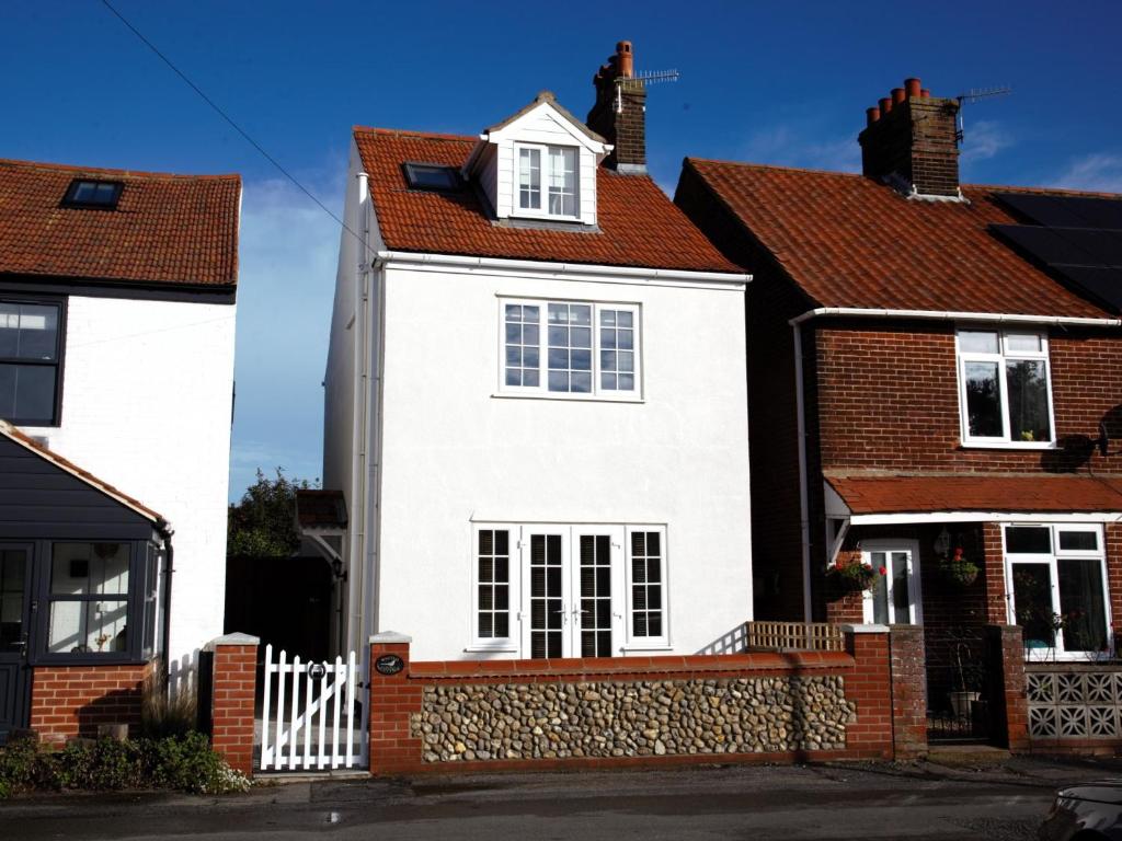a white house with a red roof at 3 Bed in Sheringham 90701 in Sheringham