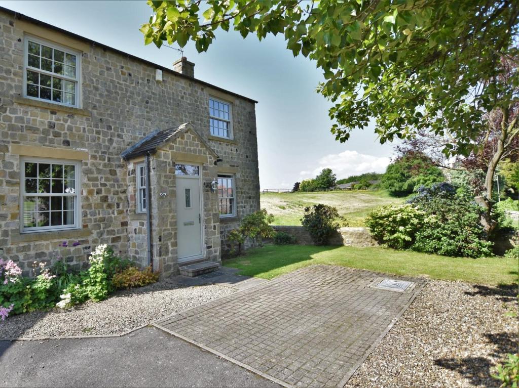an old stone house with a white door at 3 Bed in Richmond 90578 in Catterick Bridge