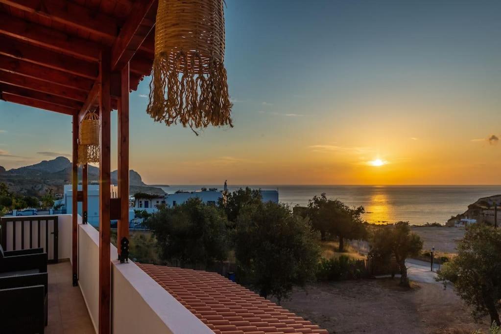 a view of the ocean at sunset from a house at Blue Bay Villas , First Floor in Archangelos