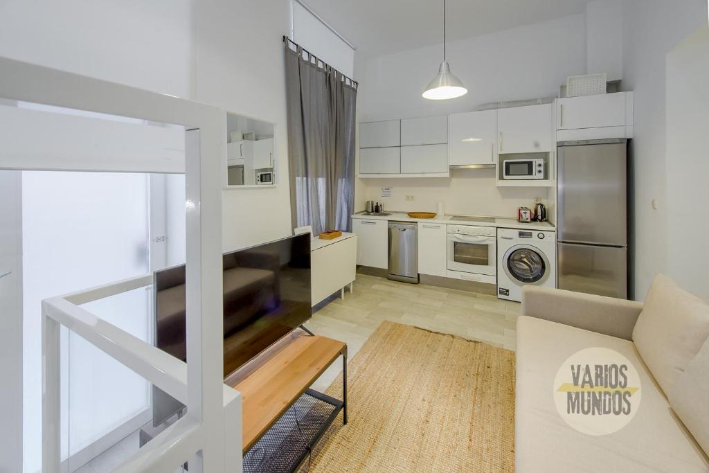 a living room with a couch and a kitchen at Stylish Loft with 2 beedrooms en el Centro - La Latina in Madrid