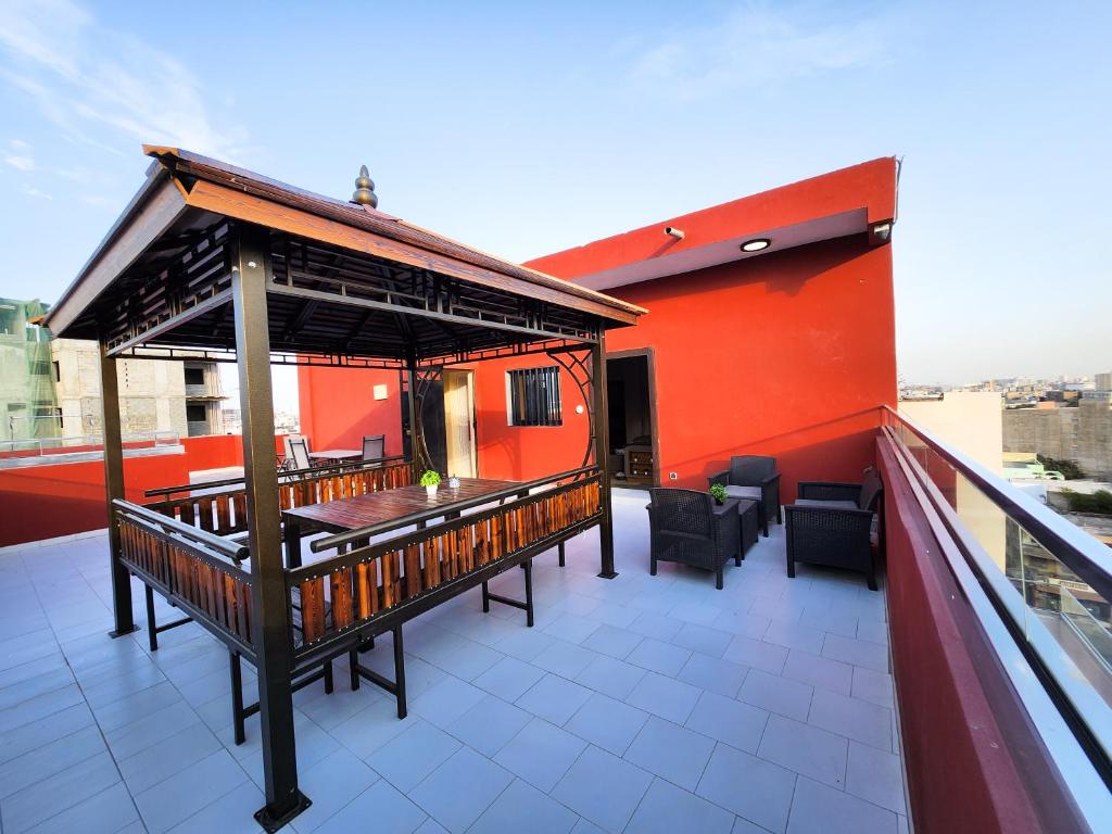 a balcony with a gazebo on top of a building at F3 Appartement Point E Dakar in Dakar