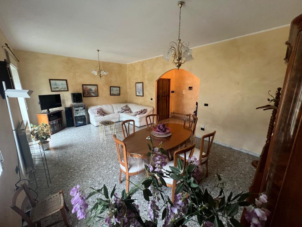 a dining room and living room with a table and chairs at Central House in Castel di Sangro