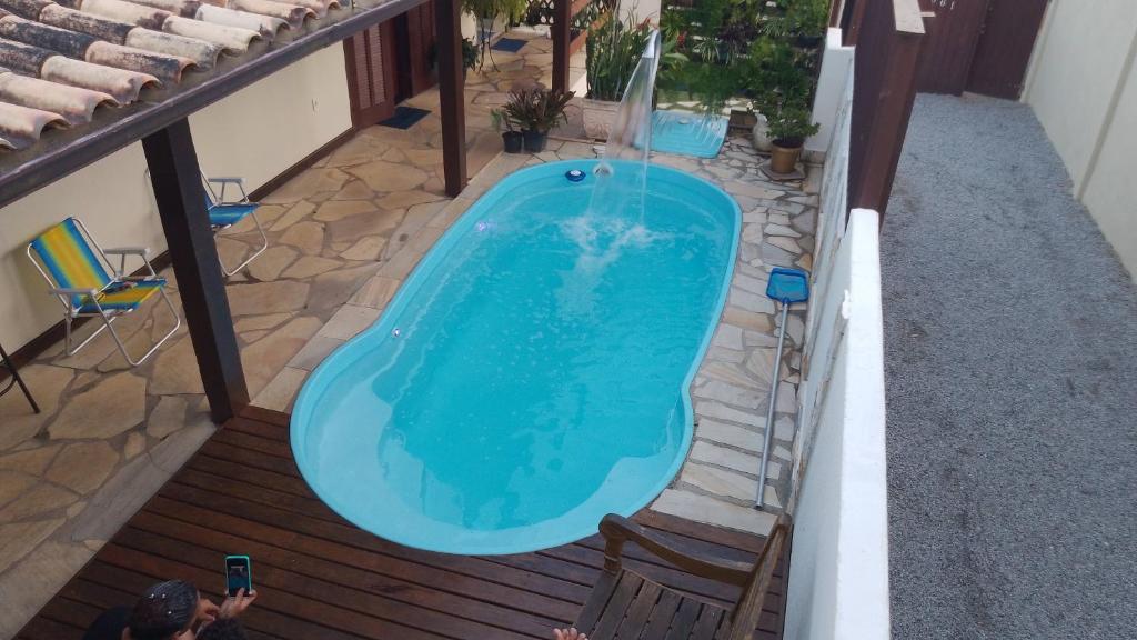 an overhead view of a swimming pool on a deck at Ramos Acomodações in Búzios