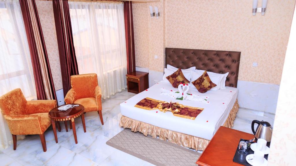 Postel nebo postele na pokoji v ubytování Easy Hotel Kenya
