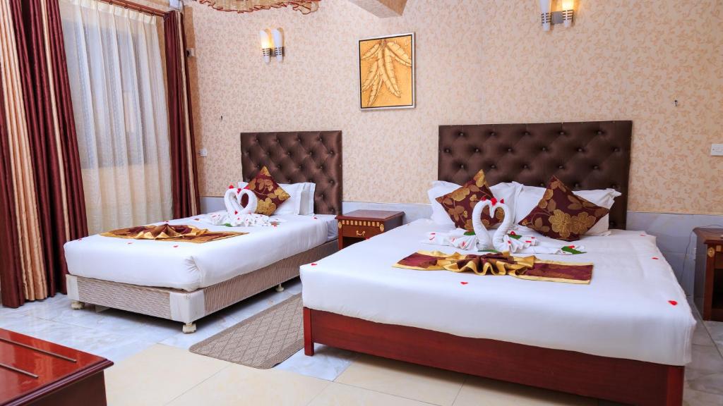 Postel nebo postele na pokoji v ubytování Easy Hotel Kenya
