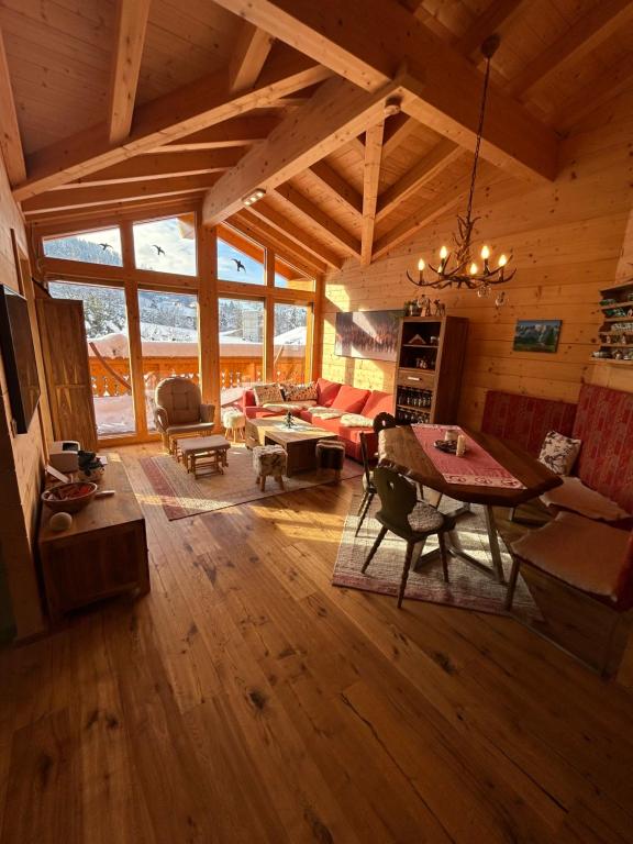 una sala de estar con mesa y sillas en una cabaña en Chalet Alma en Haus im Ennstal