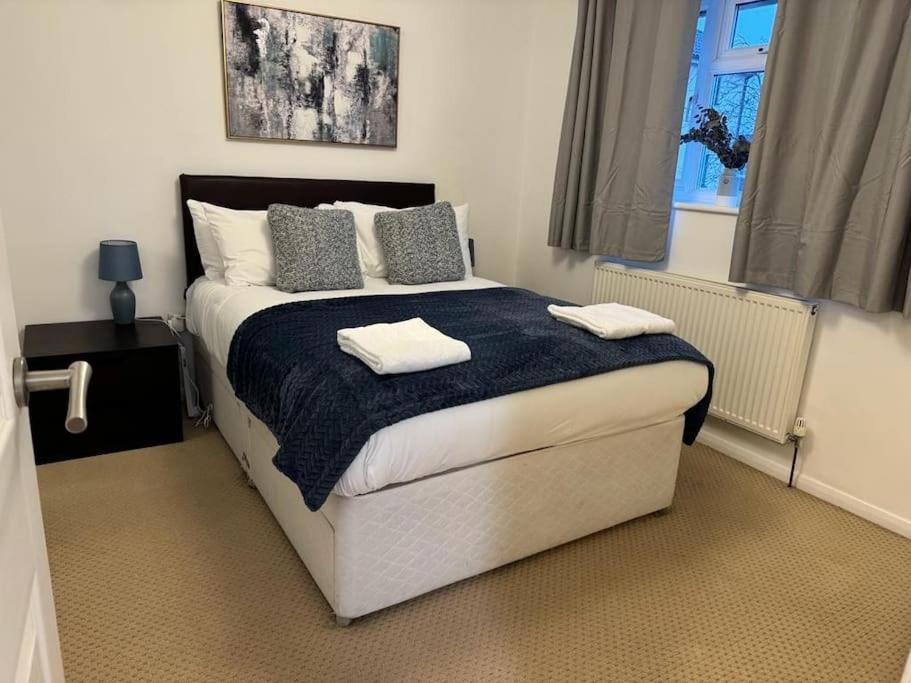 een slaapkamer met een bed met twee handdoeken erop bij Summer House Sleeps 6 , 2 Large Parking Spaces, walking distance to Cardiff Bay and City Centre in Cardiff