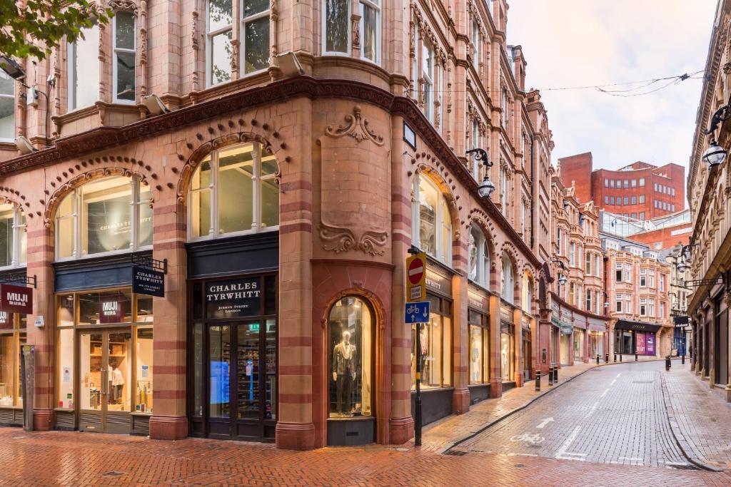 an empty street in a city with buildings at City Centre - New Street in Birmingham