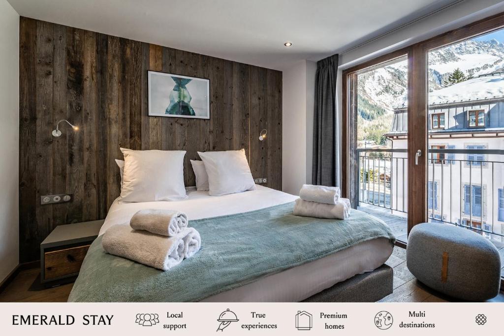 a bedroom with a bed and a large window at Chalet Herzog Argentière Chamonix - by EMERALD STAY in Chamonix