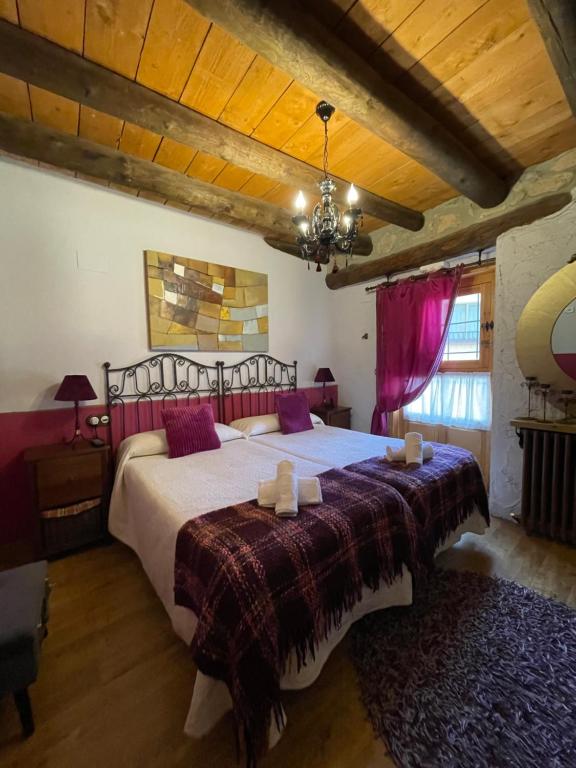 a bedroom with a large bed in a room at El Callejon De Andrese in Loarre