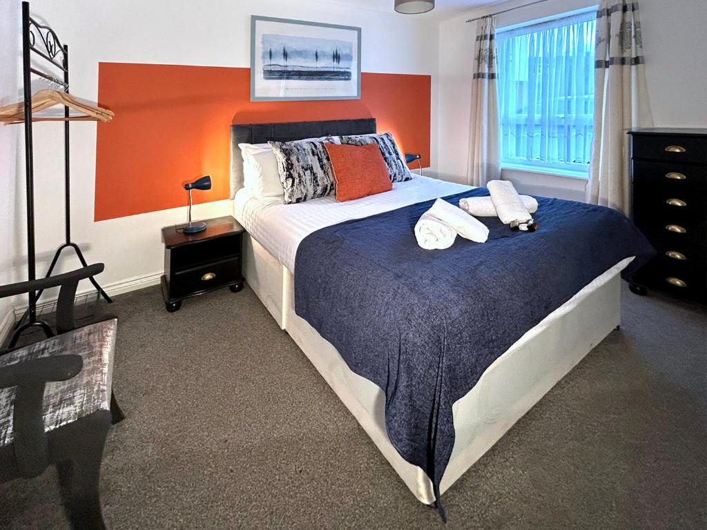 a bedroom with a bed with two towels on it at Hindmarsh Apartment in Ashington