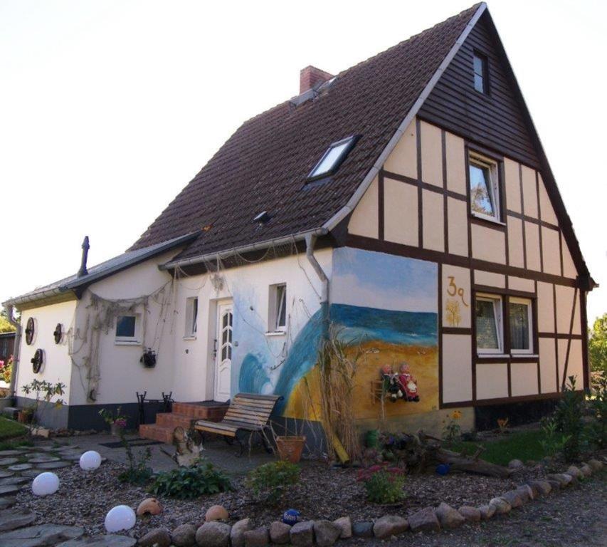 a house with a painting on the side of it at Sandburg in Zempin