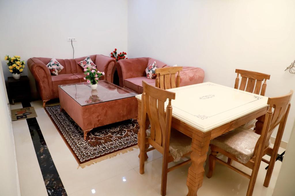 a living room with a table and a couch at Fortune Home Service Apartment 3Bhk,E-28, Saket 2B in New Delhi