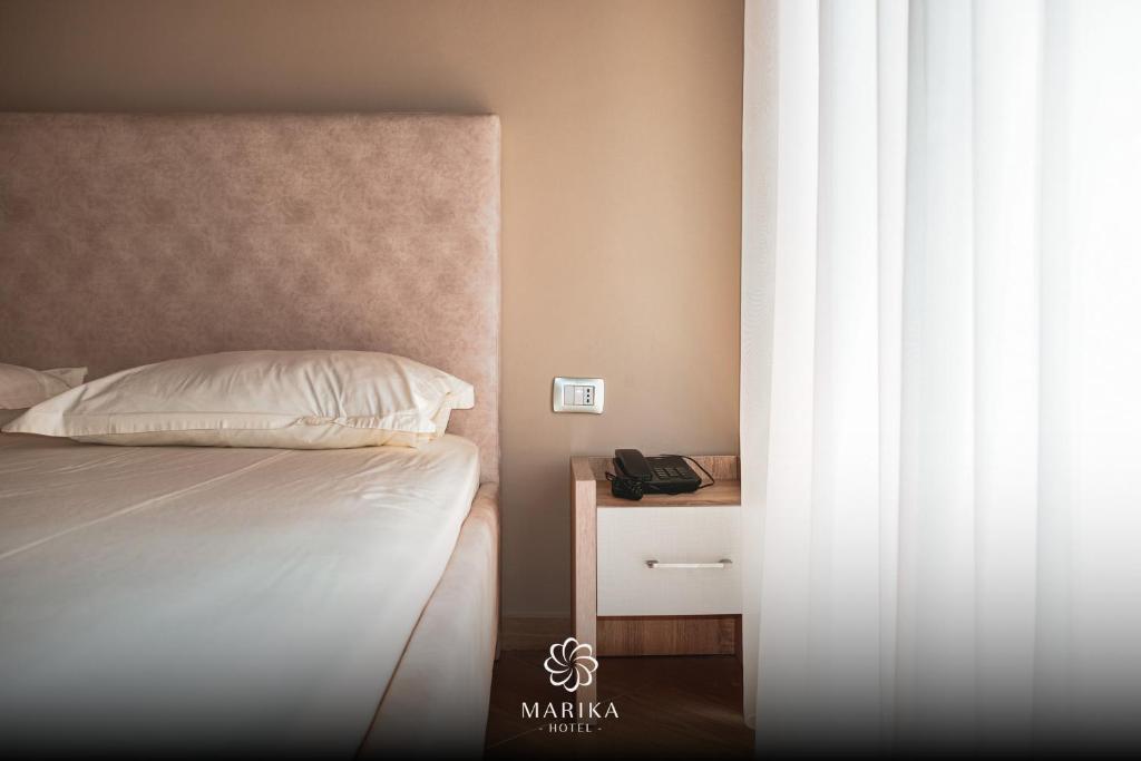 Postel nebo postele na pokoji v ubytování Hotel Marika