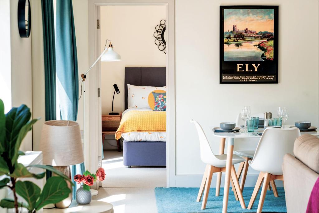 a living room with a bed and a table and chairs at Oak Cottage at Gravel Farm in Stretham