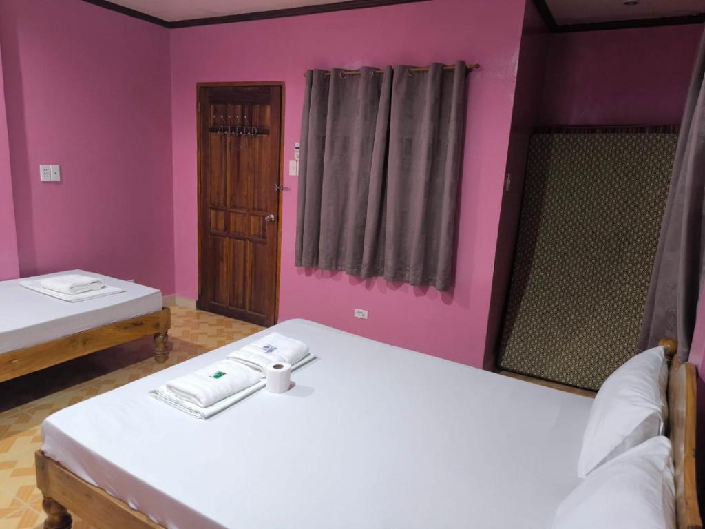 Postel nebo postele na pokoji v ubytování C.A.F. MALAPASCUA DIVA INN