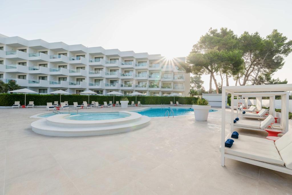 a large hotel with a pool and a resort at THB Naeco Ibiza - Adults Only in San Antonio Bay