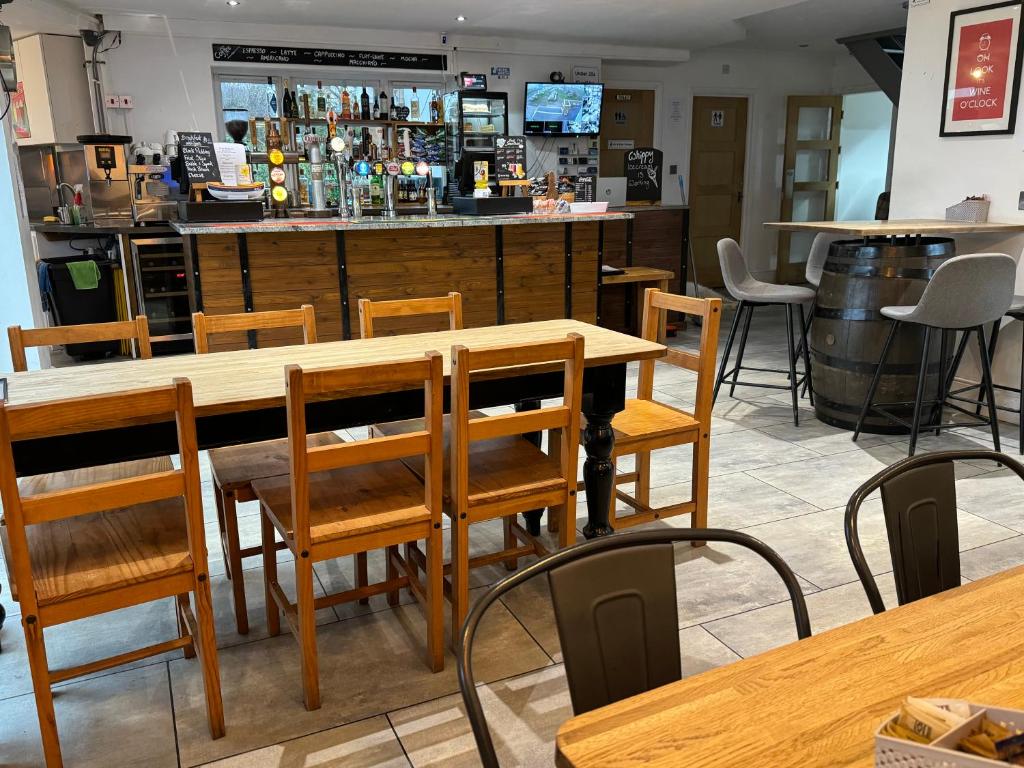 a restaurant with a table and chairs and a bar at The Waves B&B in Birchington