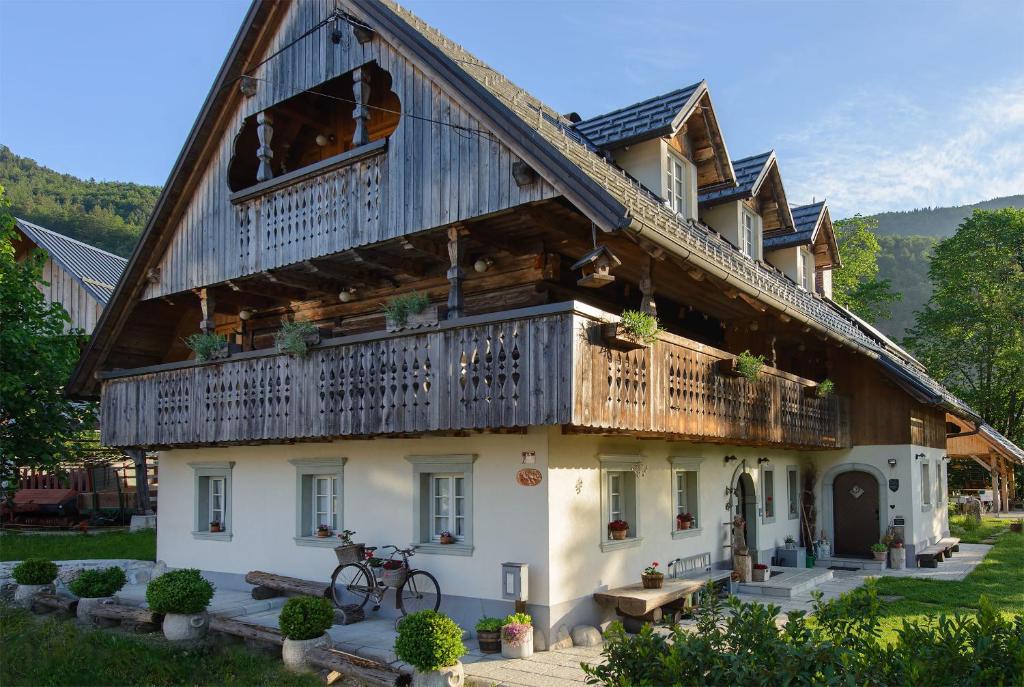 a large wooden house with a balcony at Rustic House 13 in Bohinj