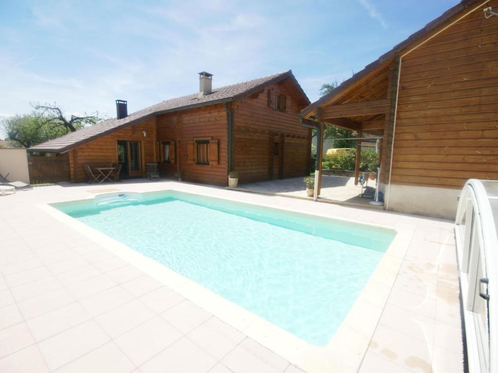 a large swimming pool in front of a house at Spacious Chalet in Abbevillers with Swimming Pool in Abbévillers