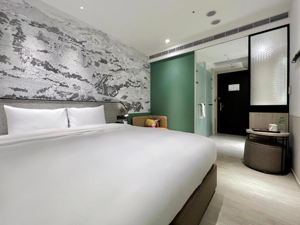 Postel nebo postele na pokoji v ubytování Boutech JianTan Hotel