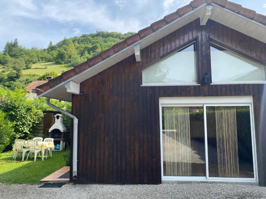 a house with a large sliding glass door at Gite du moulin in Montgesoye