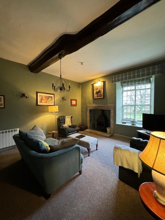 a living room with two couches and a fireplace at Braithwaite Hall Apartment in East Witton