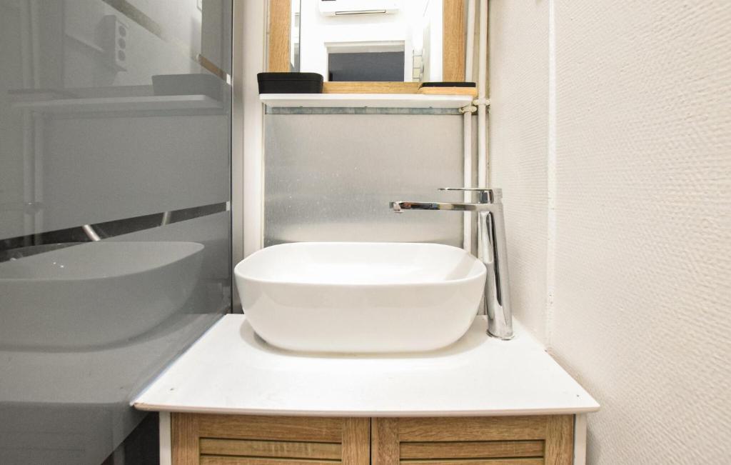 a small bathroom with a sink and a toilet at Lovely Apartment In Houlgate With Wifi in Houlgate