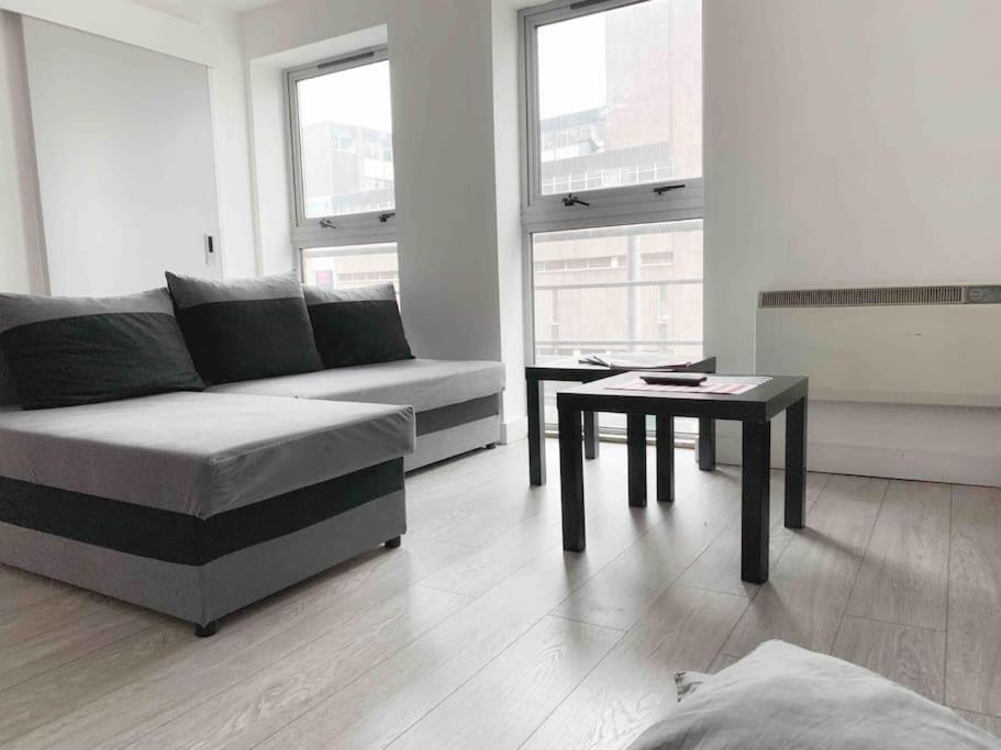 a living room with a couch and a table at New City Centre Apartment in Nottingham in Nottingham